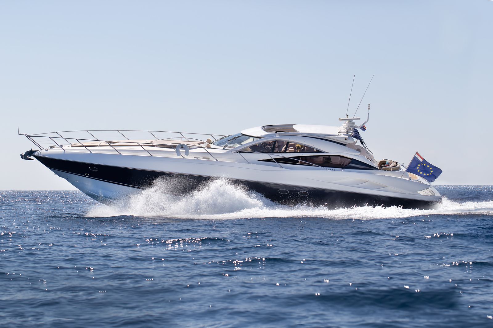 A large yacht cutting through blue water off Ibiza